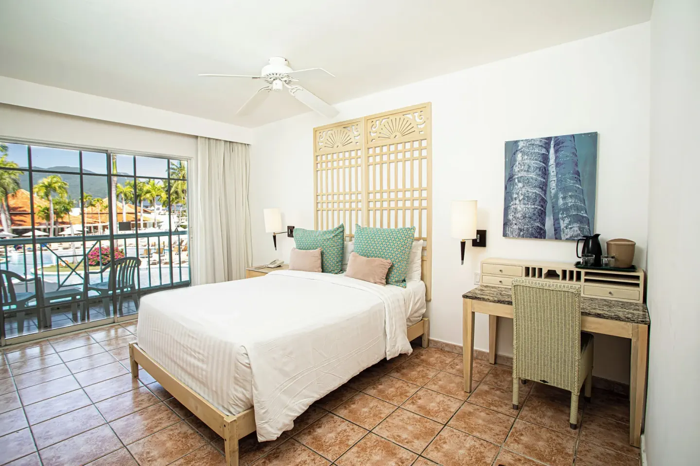 King guest room with desk and pool-view balcony at VH Gran Ventana Beach Resort.