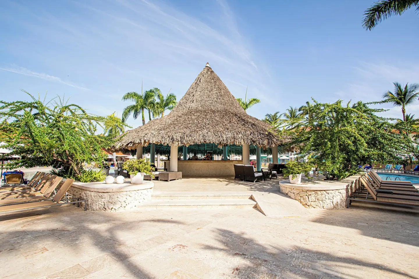 Thatched poolside pavilion surrounded by loungers at VH Gran Ventana Beach Resort.