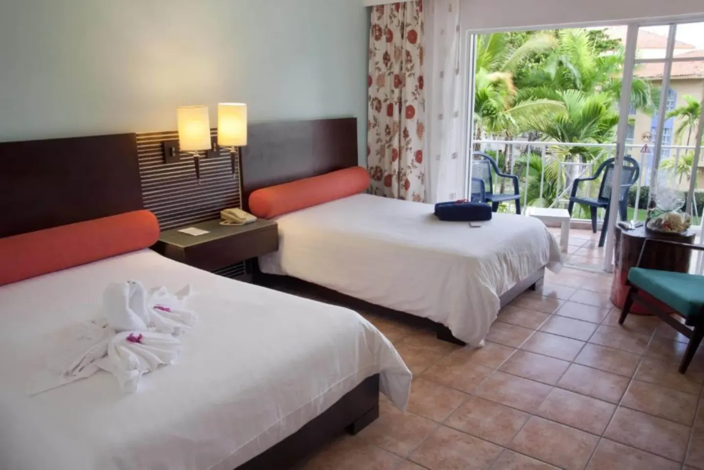 Two-bed guest room with balcony and tropical garden view at VH Gran Ventana Beach Resort.