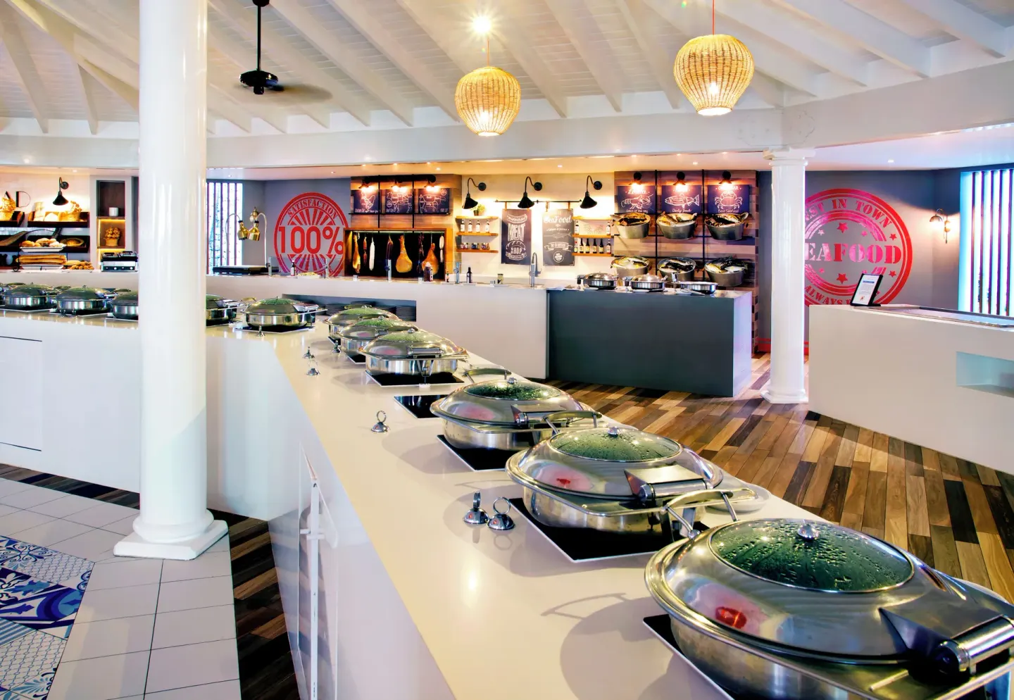 Buffet counters with covered serving dishes at VH Gran Ventana Beach Resort.