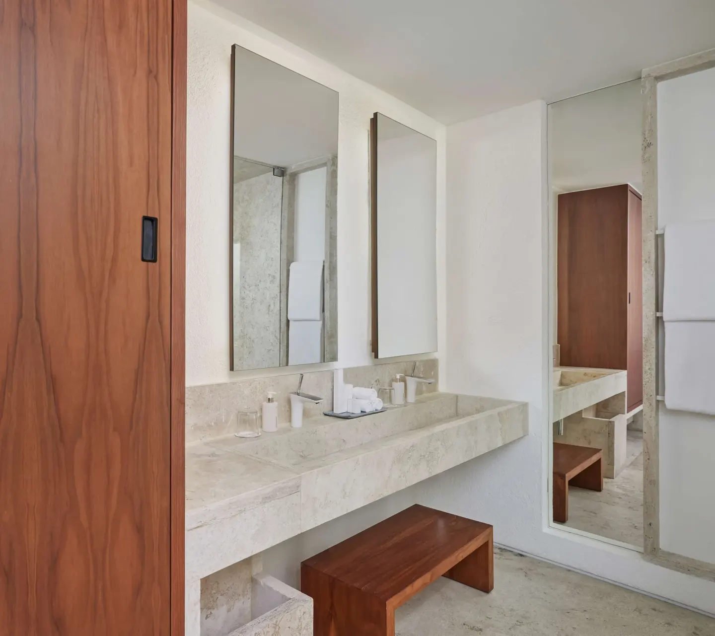 Bathroom vanity with twin mirrors and stone counter at Viceroy Los Cabos.