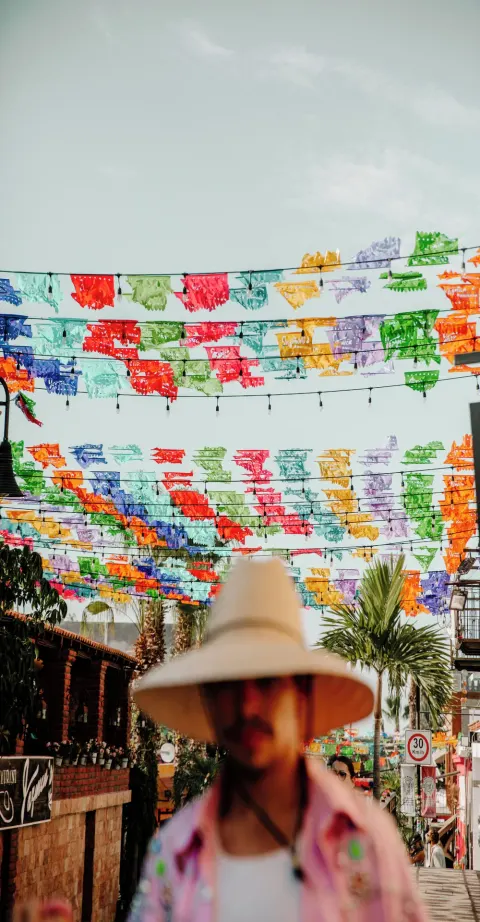 Colorful papel picado banners over a street scene near Viceroy Los Cabos.