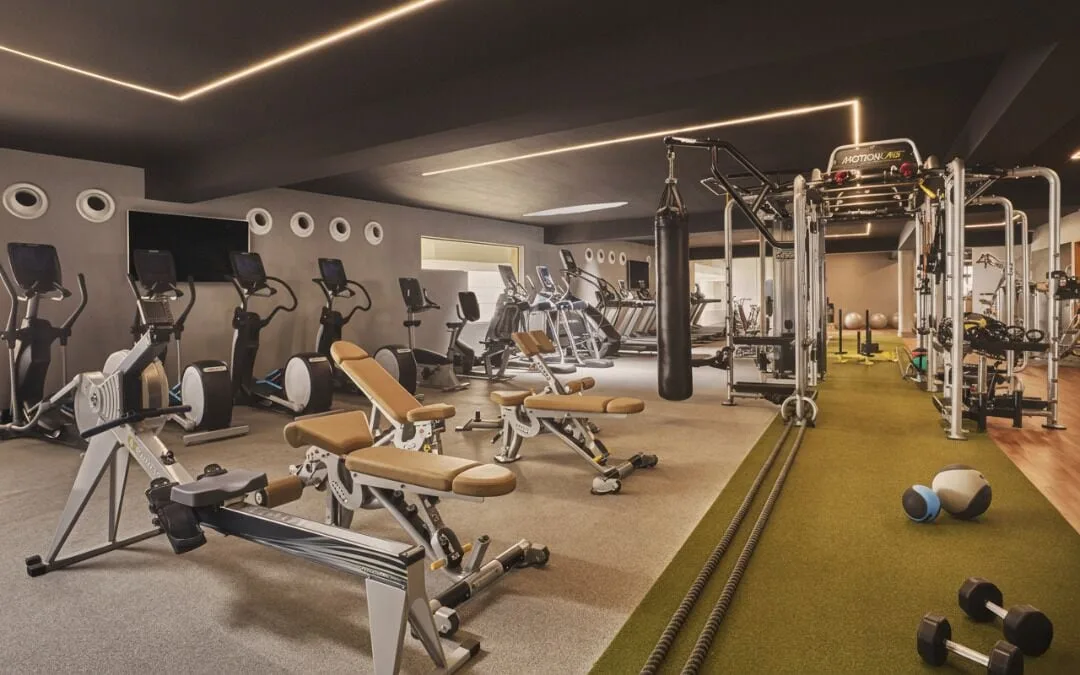 Fitness center with cardio machines, benches, turf, and training equipment at Viceroy Los Cabos.