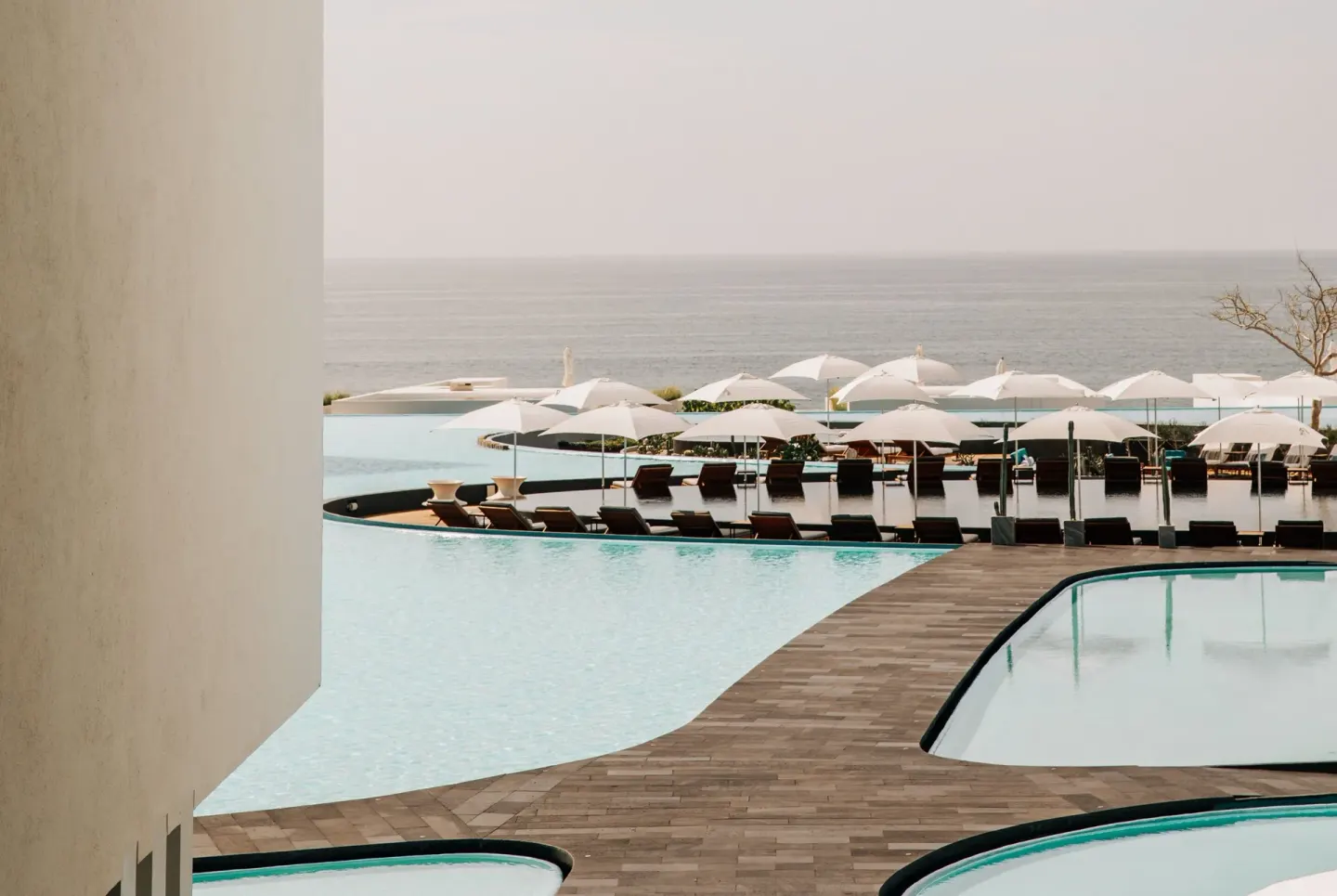Pools, loungers and umbrellas facing the ocean at Viceroy Los Cabos.