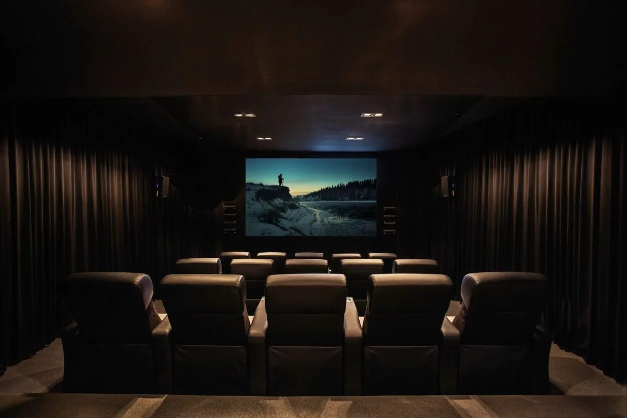 A dark private screening room with leather seats at Viceroy Los Cabos.