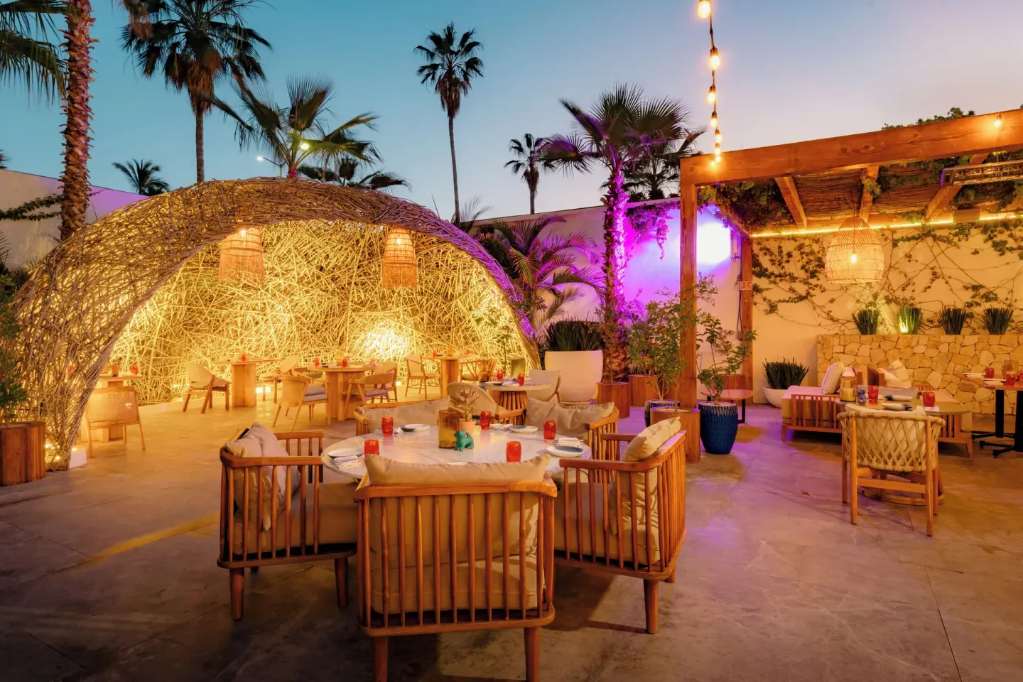 Outdoor dining patio with woven nest structure at NIDO at Viceroy Los Cabos.