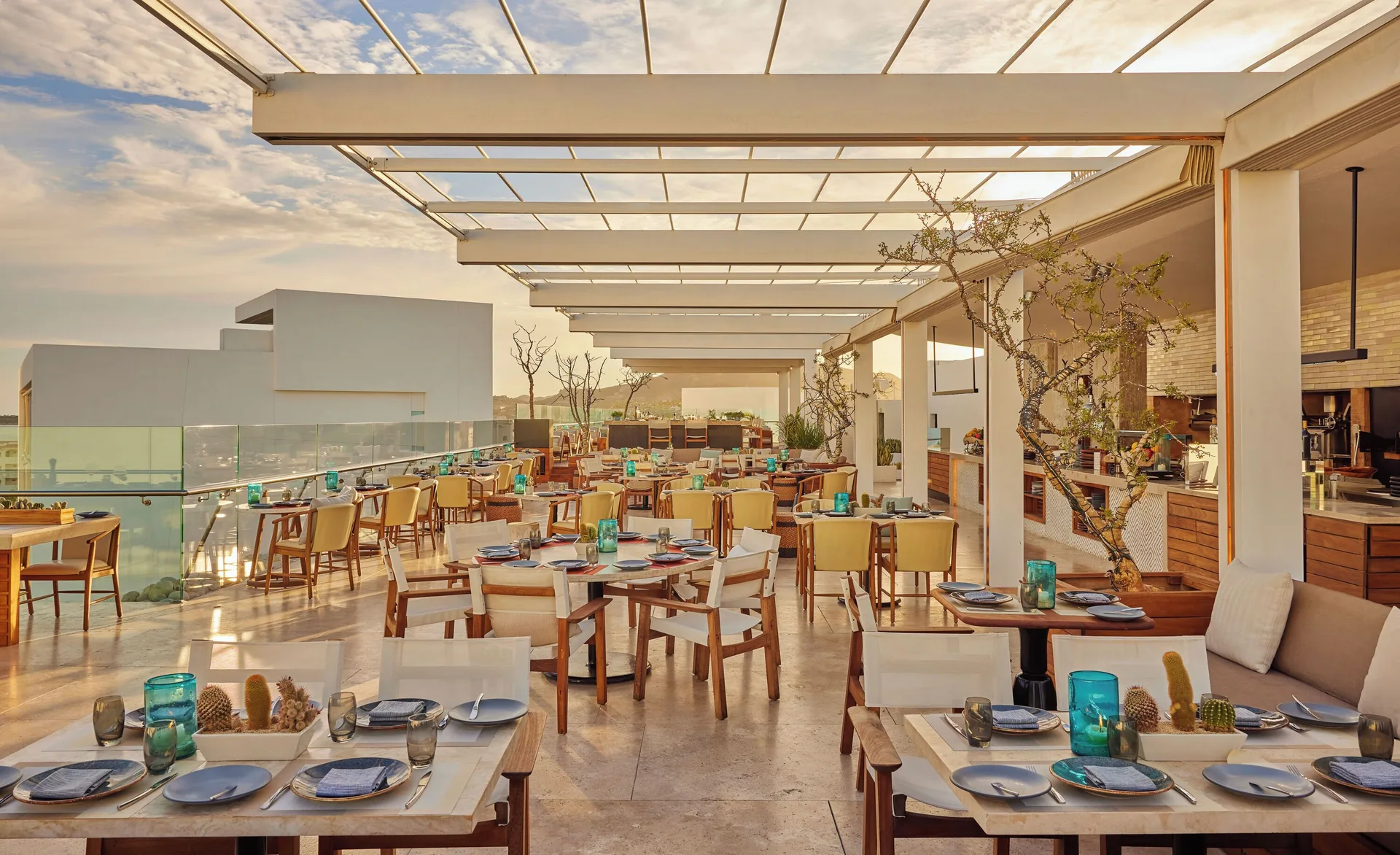 An open-air rooftop dining terrace is set for service at Viceroy Los Cabos.