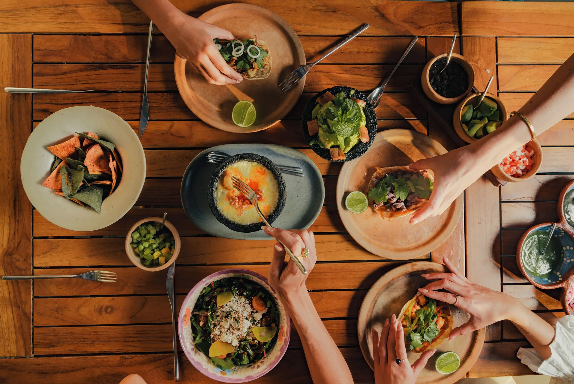 Overhead view of tacos, dips, salad and shared plates at Viceroy Los Cabos.