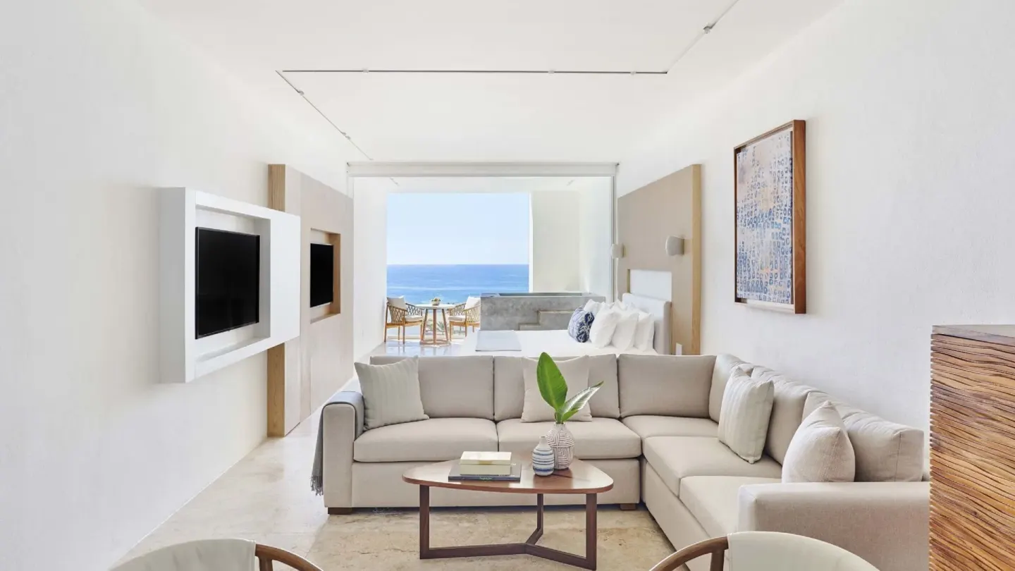 Junior Suite Ocean View living area with bed, sofa, terrace, and sea view at Viceroy Los Cabos.