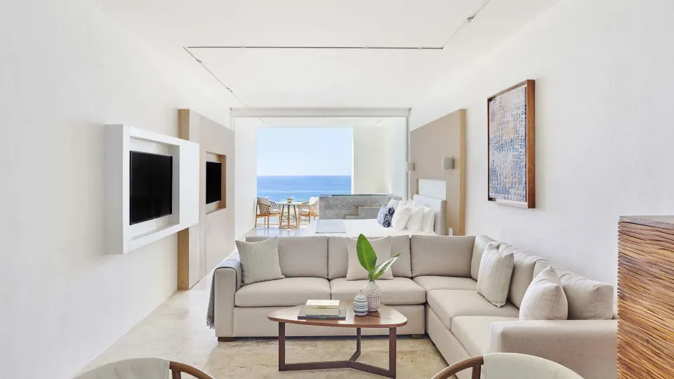 Junior Suite Ocean View living area with bed, sofa, terrace, and sea view at Viceroy Los Cabos.