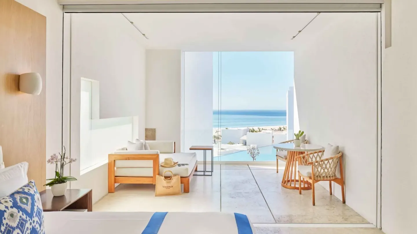 Junior Suite with king bed, terrace seating, and partial ocean view at Viceroy Los Cabos.