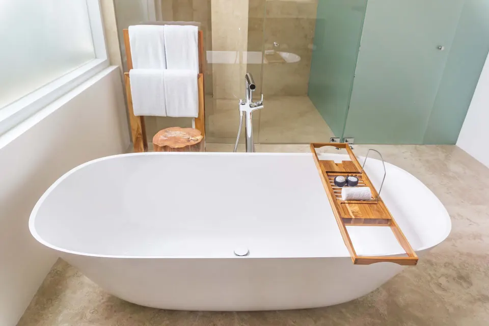 Junior Suite bathroom with freestanding tub and glass shower at Viceroy Los Cabos.