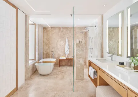 Junior Suite bathroom with tub, glass shower, and double vanity at Viceroy Los Cabos.