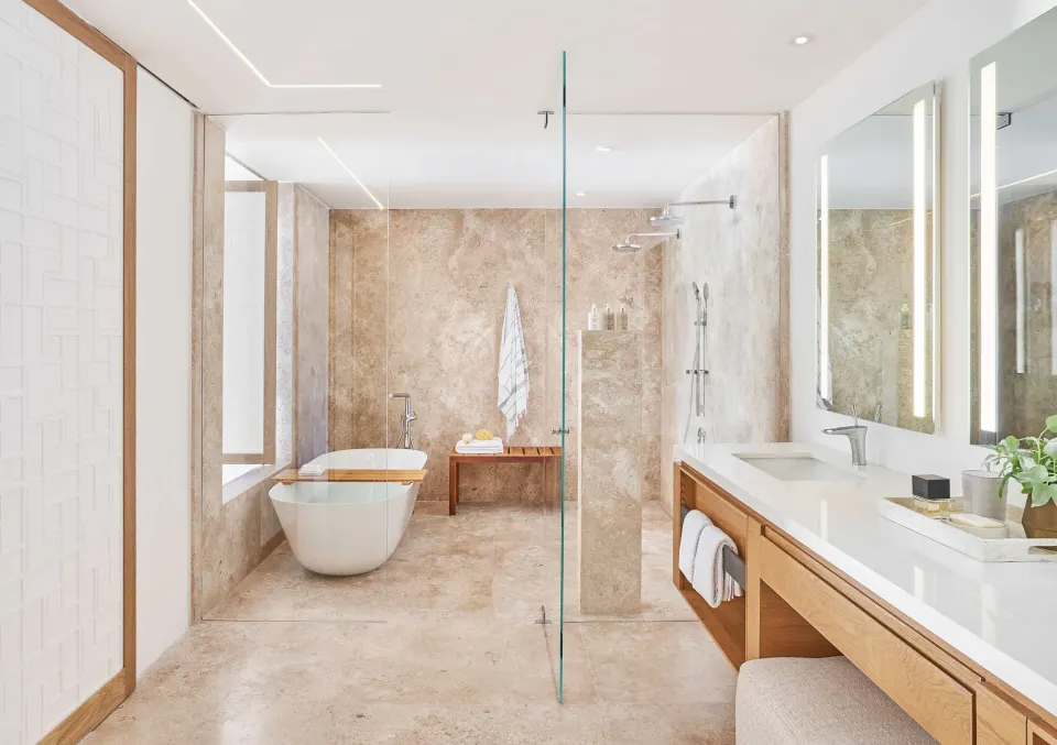 Junior Suite bathroom with tub, glass shower, and double vanity at Viceroy Los Cabos.