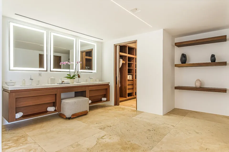 Penthouse bathroom vanity with mirrors and walk-in closet at Viceroy Los Cabos.