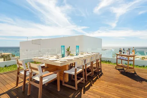 Penthouse outdoor dining table with ocean view at Viceroy Los Cabos.