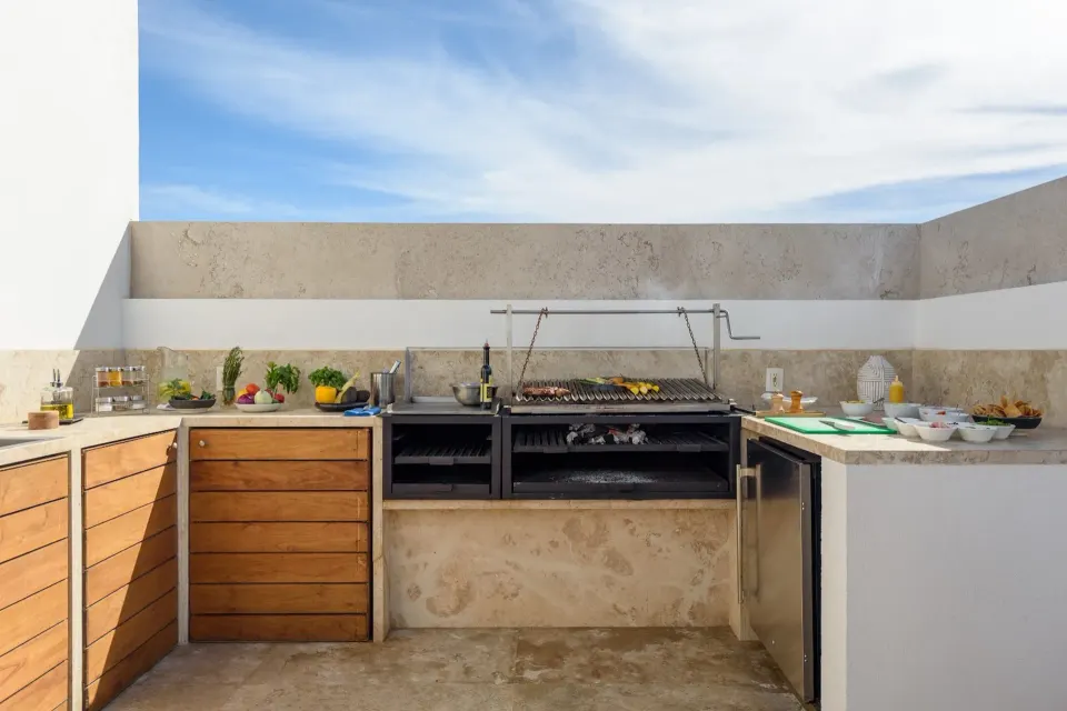 Penthouse outdoor grill kitchen with prepared ingredients at Viceroy Los Cabos.