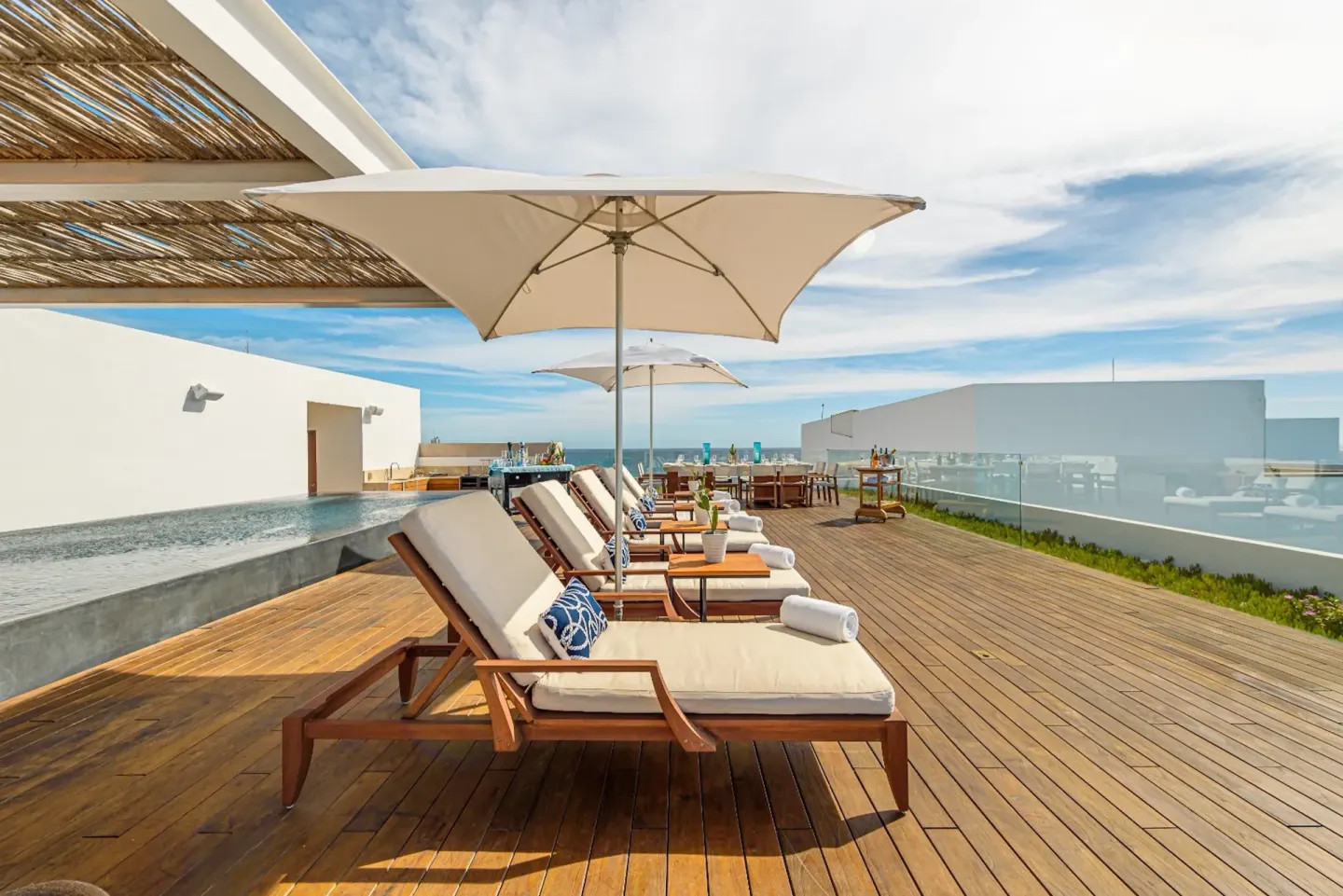 Penthouse terrace loungers with umbrellas and ocean view at Viceroy Los Cabos.