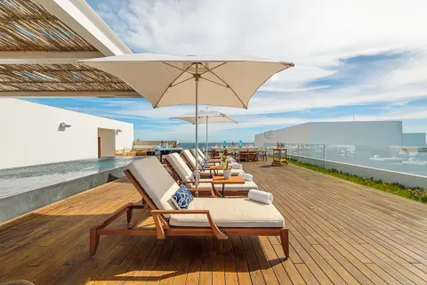 Penthouse terrace loungers with umbrellas and ocean view at Viceroy Los Cabos.