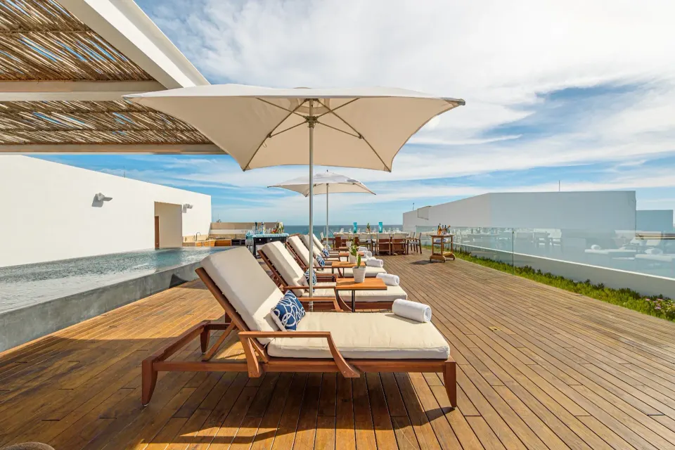 Penthouse terrace loungers with umbrellas and ocean view at Viceroy Los Cabos.