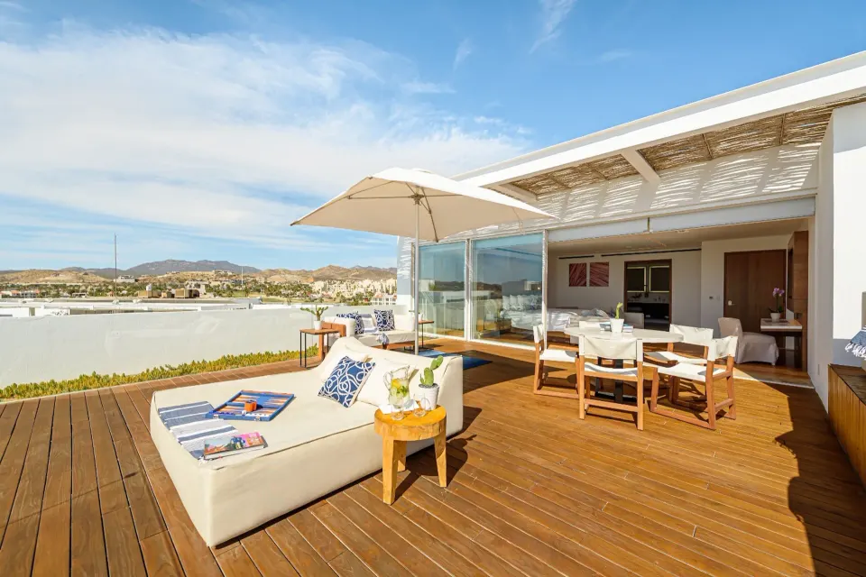 Penthouse terrace seating and dining area outside the bedroom at Viceroy Los Cabos.