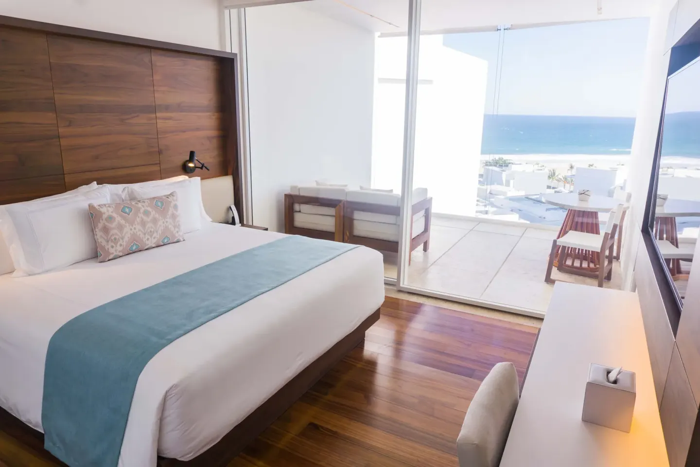 Penthouse ocean-view bedroom with balcony seating at Viceroy Los Cabos.