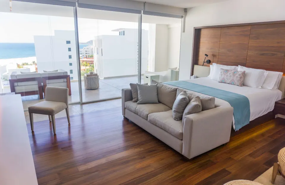 Penthouse bedroom with sofa and ocean-facing terrace at Viceroy Los Cabos.