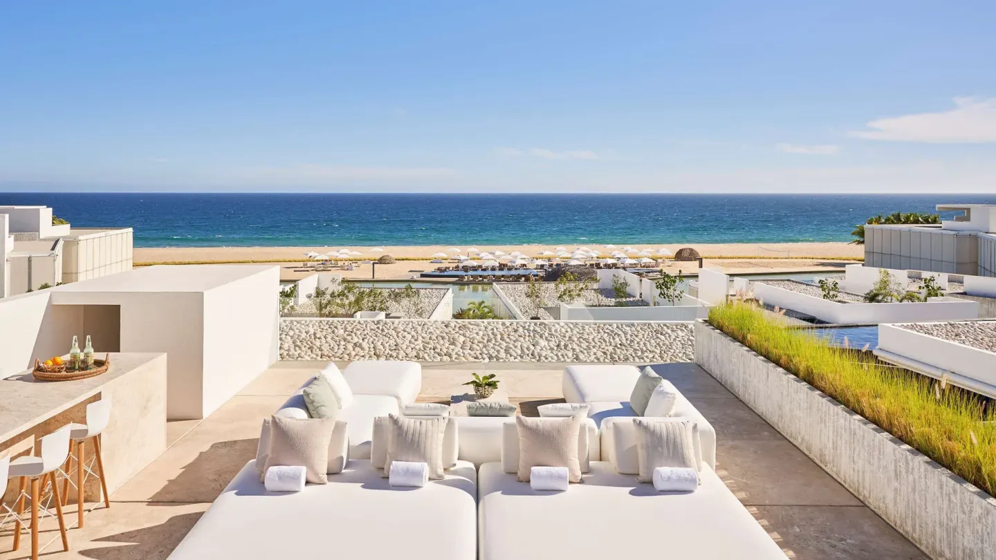 Ocean-view terrace of a 3 Bedroom Waterside Casita at Viceroy Los Cabos with daybeds and lounge seating.