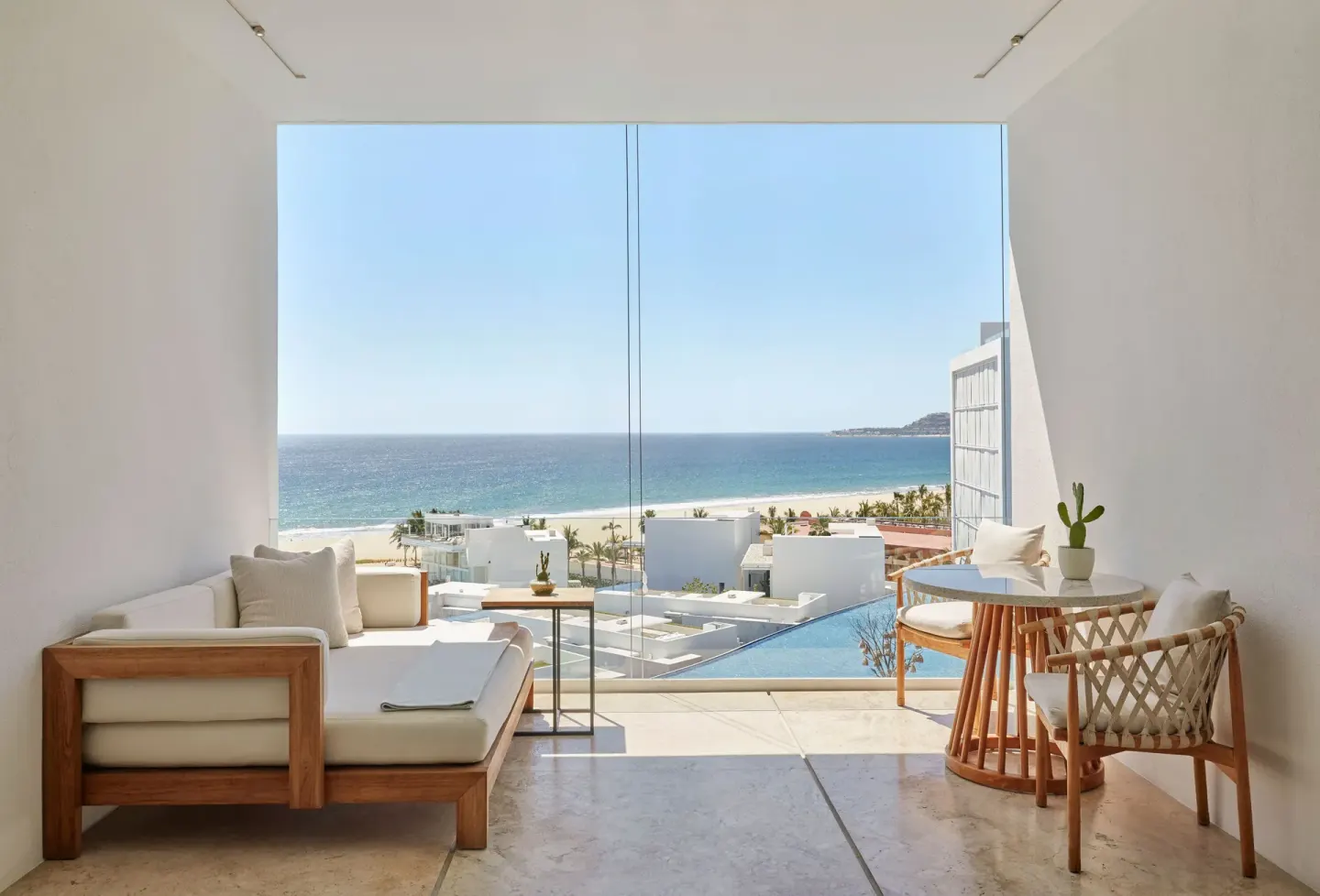 Ocean View room balcony with daybed and dining set at Viceroy Los Cabos overlooking the sea.