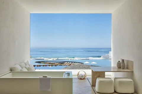 Ocean View room bath area at Viceroy Los Cabos with soaking tub, stools, and sea view.