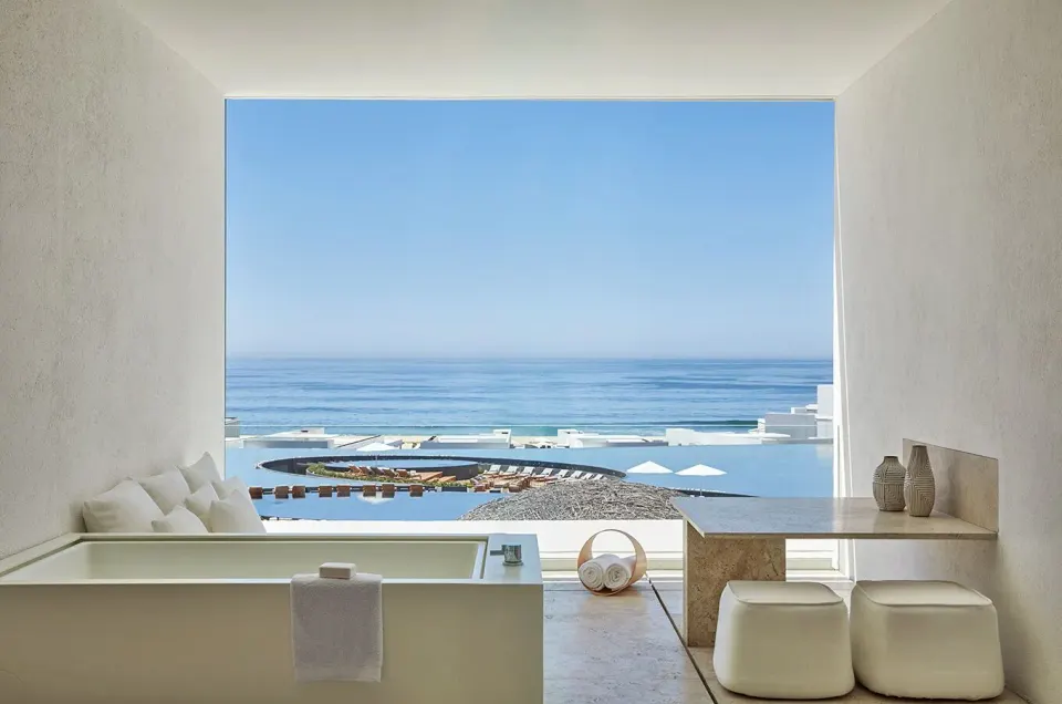 Ocean View room bath area at Viceroy Los Cabos with soaking tub, stools, and sea view.