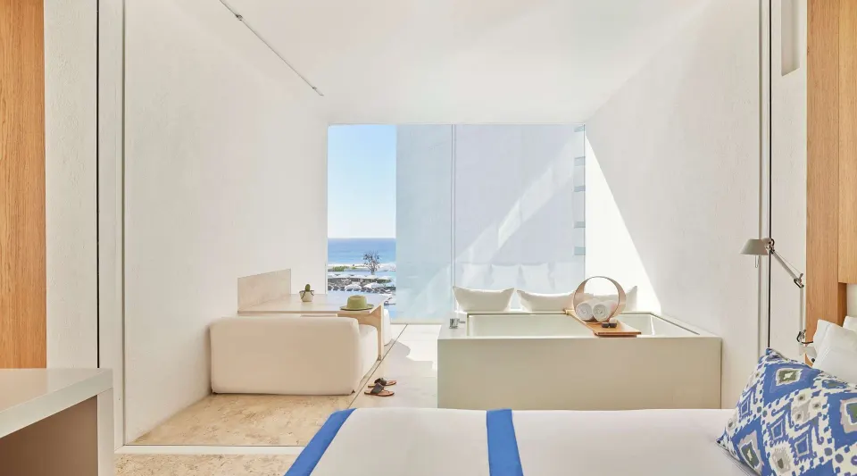 Bed, balcony tub, and partial ocean view in a Partial Ocean View room at Viceroy Los Cabos.