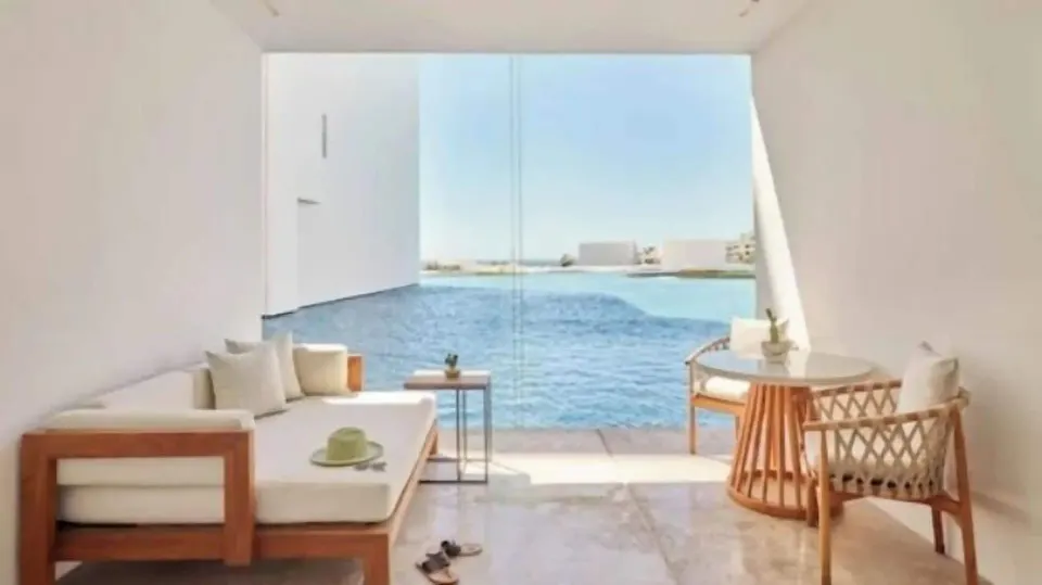 Private terrace seating beside blue water in a Partial Ocean View room at Viceroy Los Cabos.