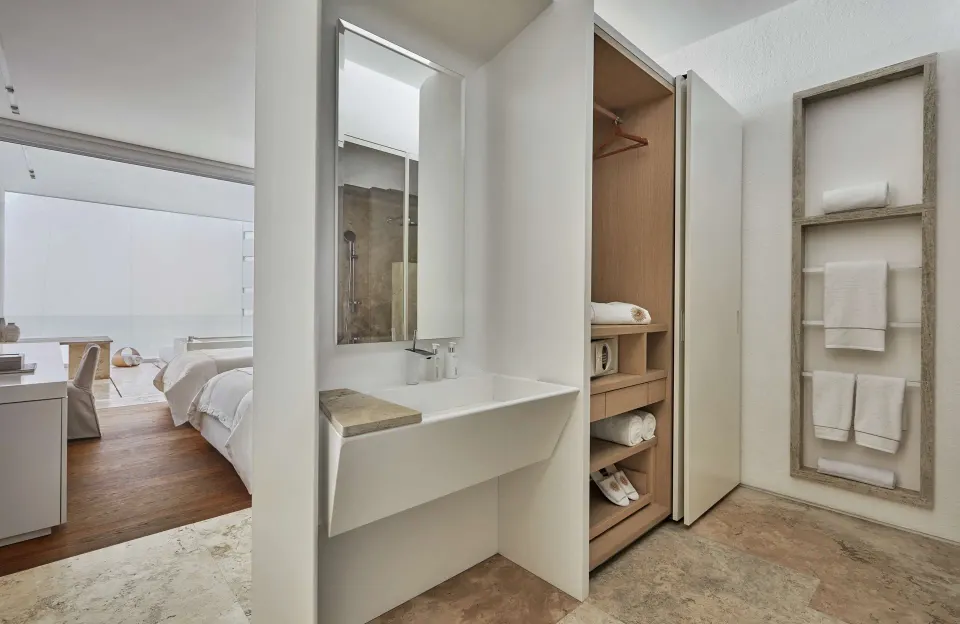 Bathroom vanity and open closet in a Partial Ocean View room at Viceroy Los Cabos.