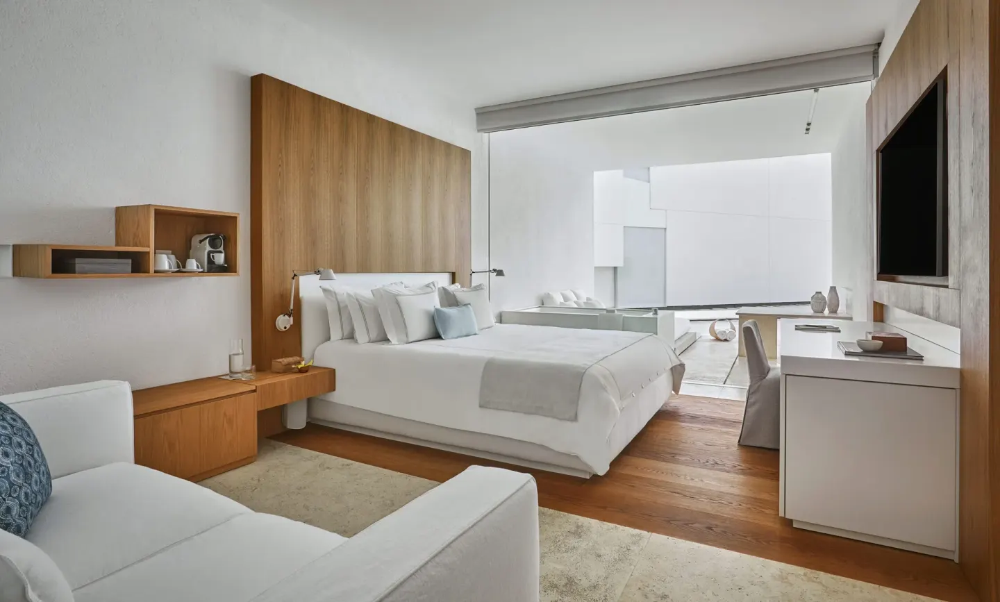 Resort View room with king bed, seating area and terrace at Viceroy Los Cabos.
