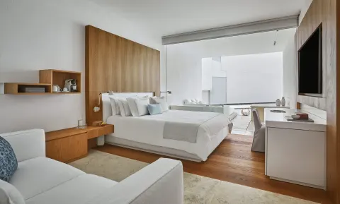 Resort View room with king bed, seating area and terrace at Viceroy Los Cabos.