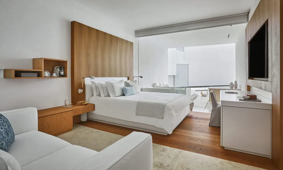 Resort View room with king bed, seating area and terrace at Viceroy Los Cabos.