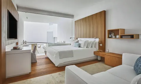 Resort View room with king bed, sofa, desk and open terrace at Viceroy Los Cabos.