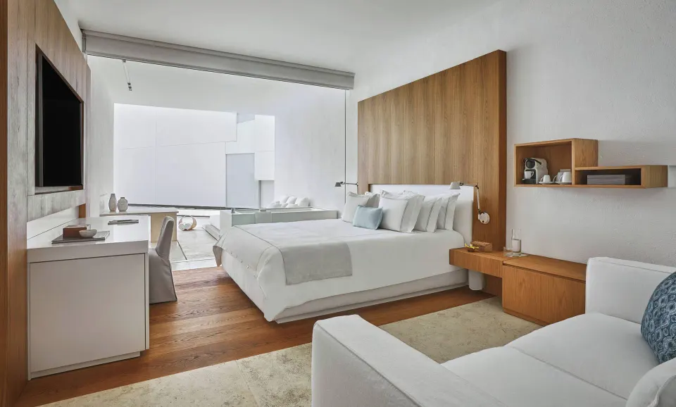Resort View room with king bed, sofa, desk and open terrace at Viceroy Los Cabos.