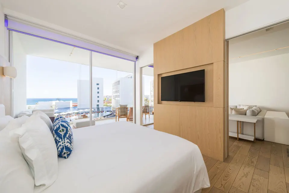 One Bedroom Partial Ocean View suite bedroom with balcony and ocean glimpse at Viceroy Los Cabos.