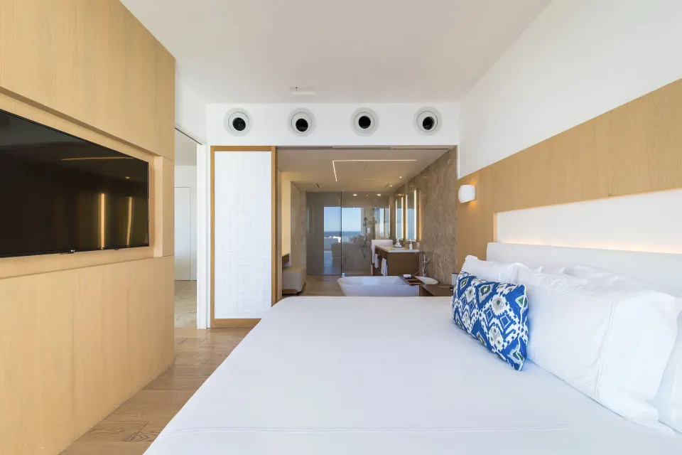 One Bedroom Partial Ocean View suite king bed facing TV and bath at Viceroy Los Cabos.