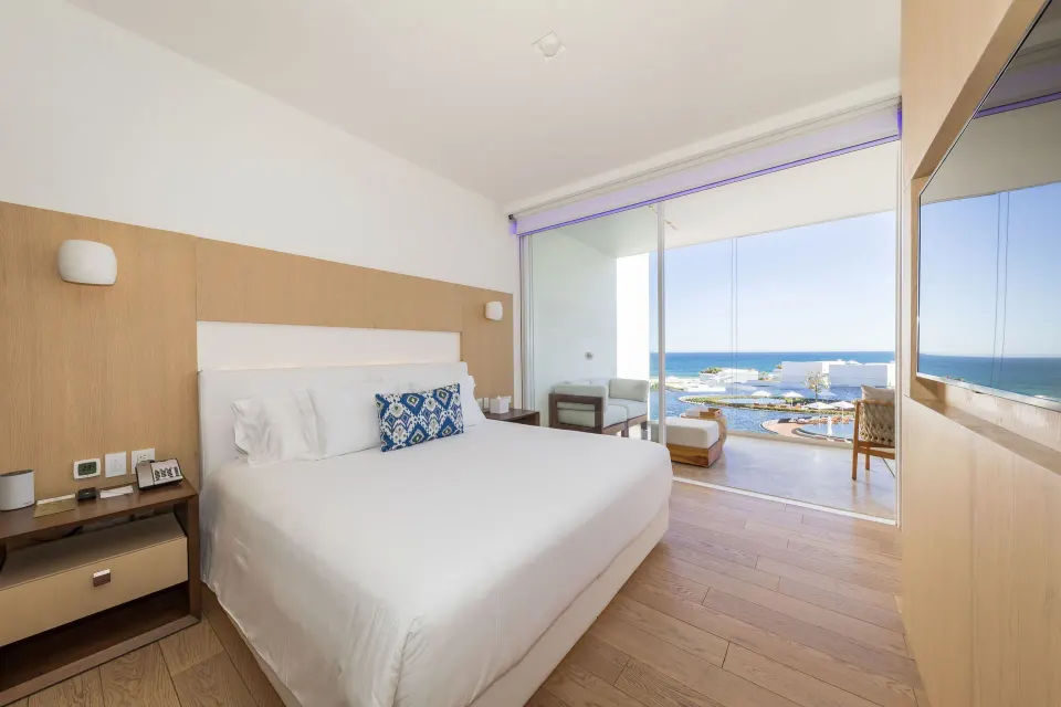 One Bedroom Partial Ocean View suite bedroom with ocean-facing balcony at Viceroy Los Cabos.