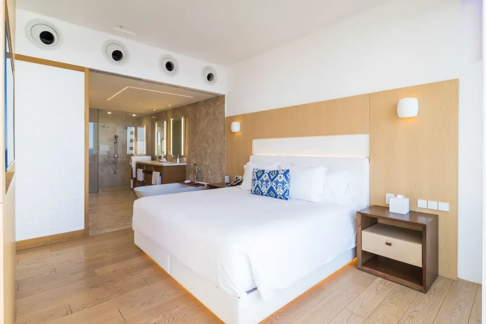 One Bedroom Partial Ocean View suite king bed and open bathroom at Viceroy Los Cabos.