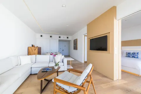One-bedroom partial ocean view suite living room and bedroom at Viceroy Los Cabos.
