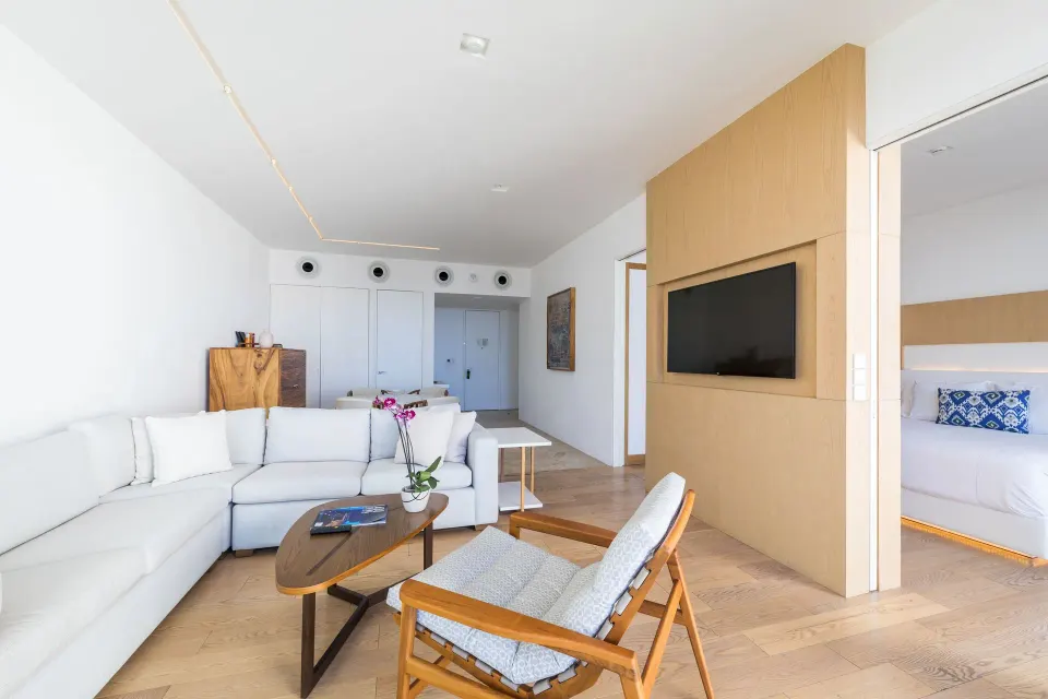 One-bedroom partial ocean view suite living room and bedroom at Viceroy Los Cabos.