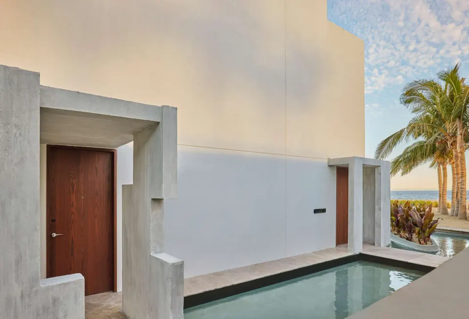 Ground-floor suite entry beside a narrow reflecting pool at Viceroy Los Cabos.
