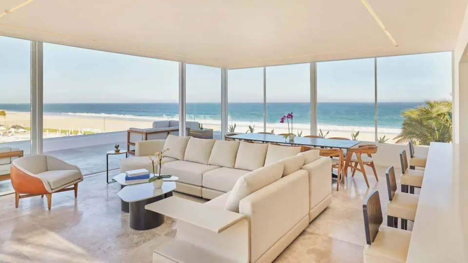 Ocean-view suite living and dining area with sectional sofa at Viceroy Los Cabos.
