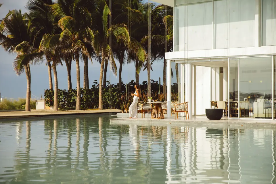 Ground-floor suite terrace by water and palms at Viceroy Los Cabos.