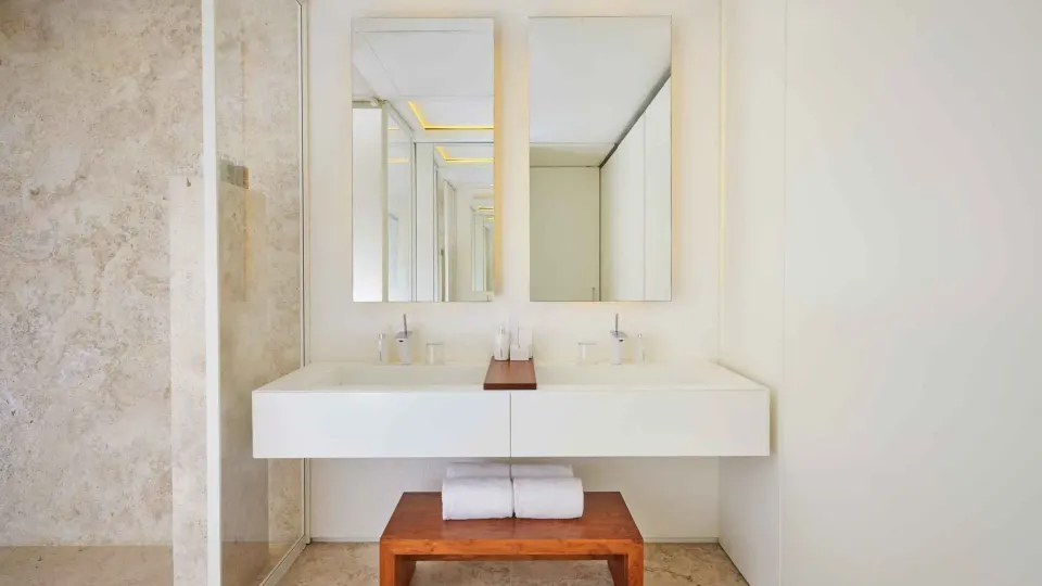 Double vanity and bench in a two-bedroom ocean view suite bathroom at Viceroy Los Cabos.