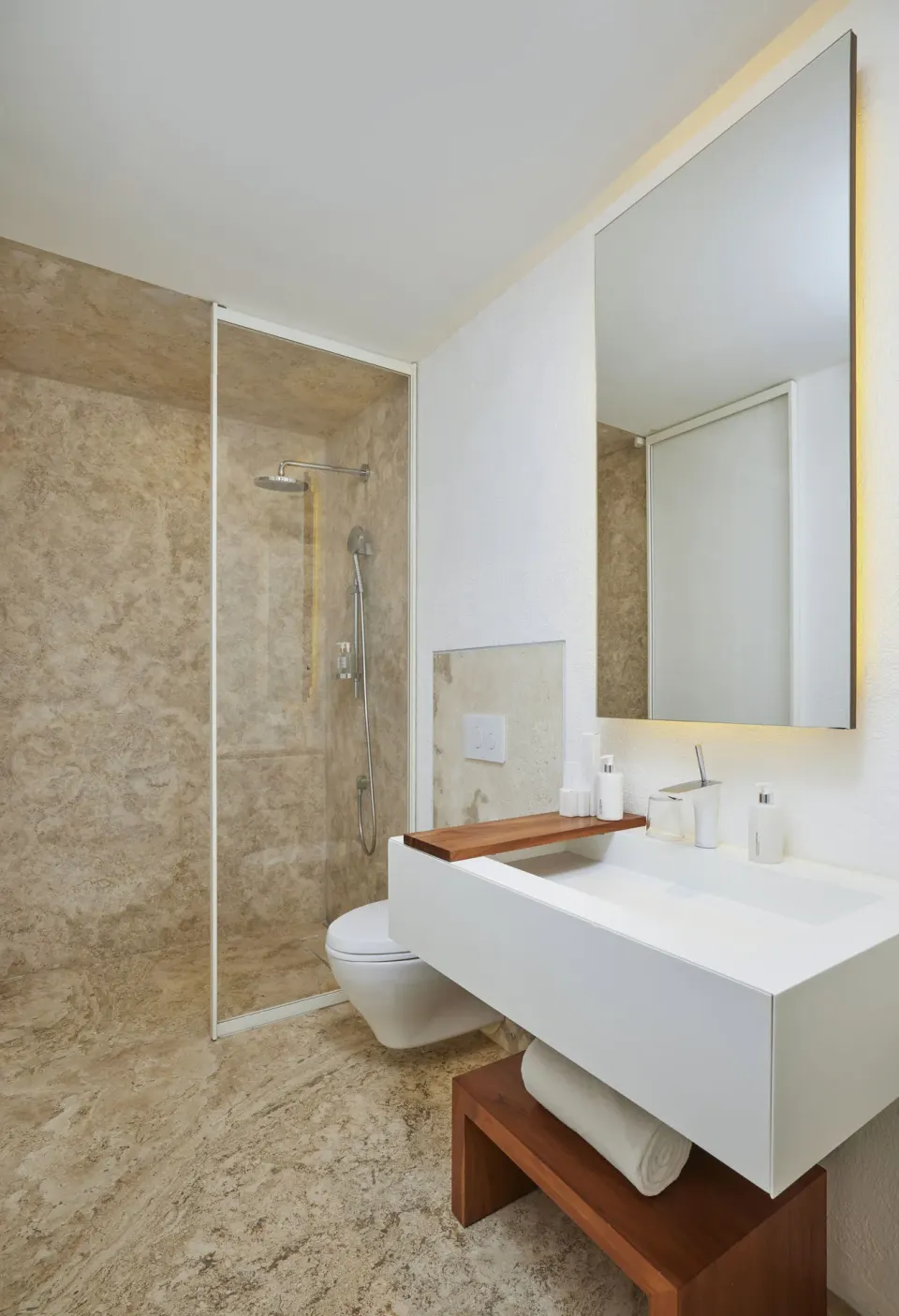 Suite bathroom with walk-in shower, vanity, and tall mirror at Viceroy Los Cabos.